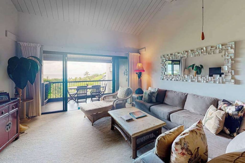 Living room comfortable seating beside ocean facing glass doors
