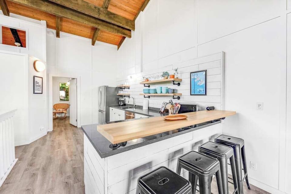 Bright kitchen island supplies stools prep space and modern appliances