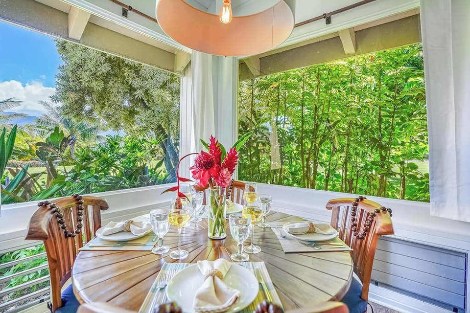 Enjoy outdoor dining on the covered lanai overlooking the tropical gardens.