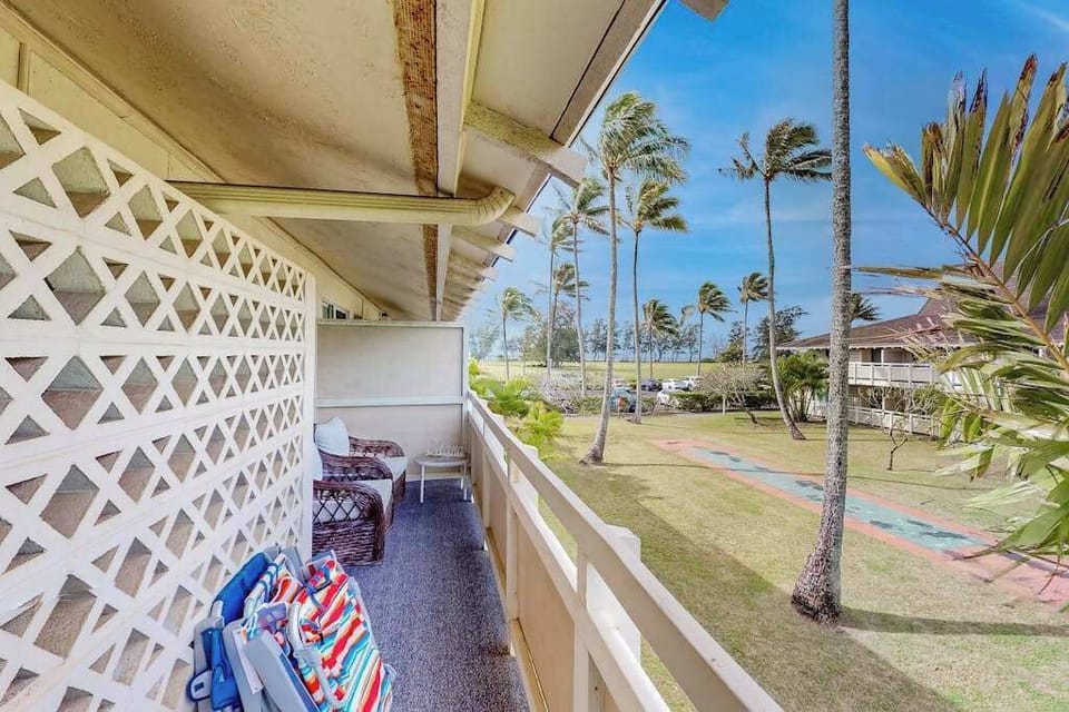 The living area seamlessly opens onto a private lanai with comfortable seating and impressive views of the mountains and surrounding landscape.