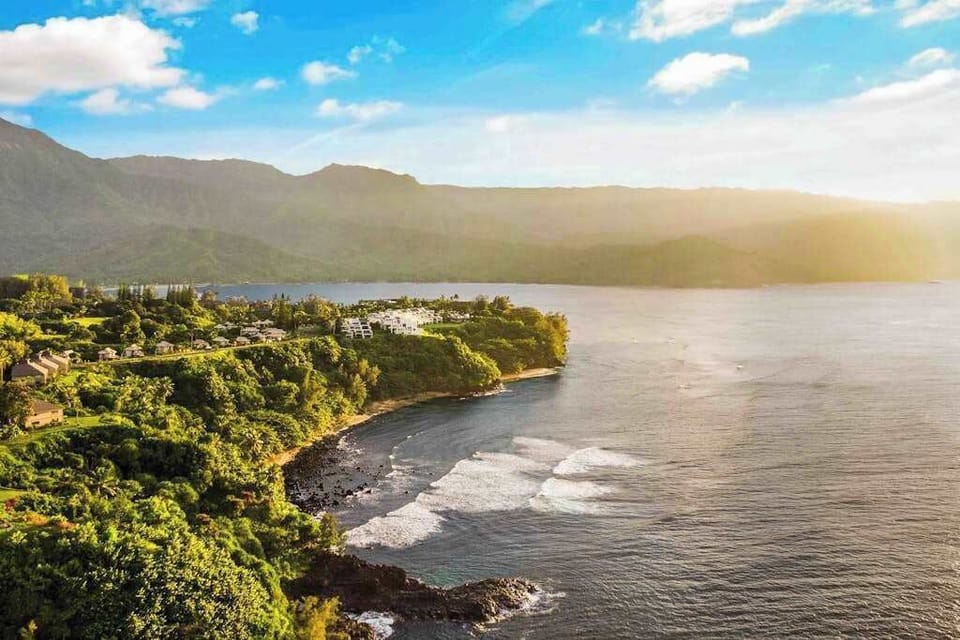 Scenic coastline framed by lush mountains and the Pacific Ocean