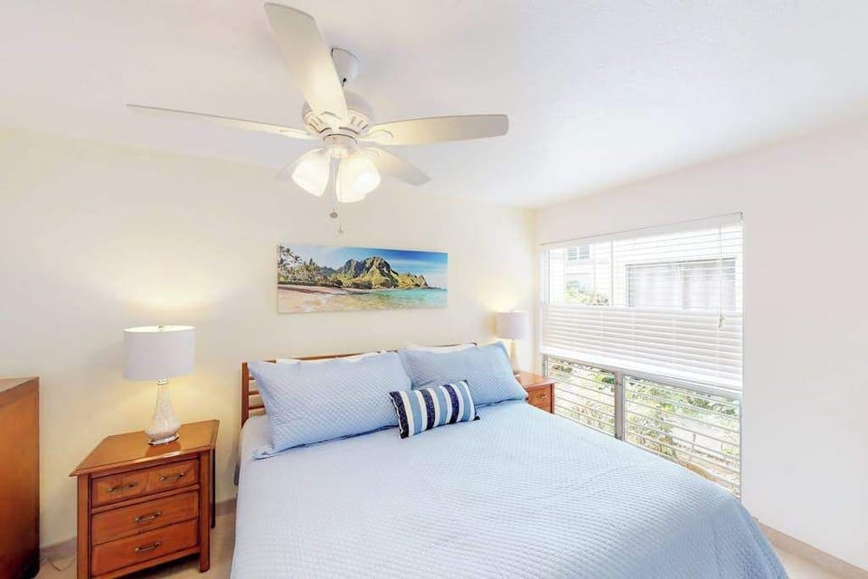 Guest room with queen bed, flat screen tv and lanai access.