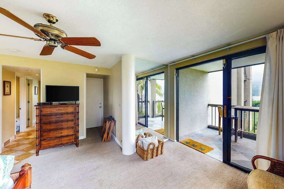 Studio opens toward balcony doors with natural light and seating