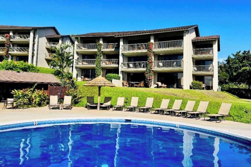 Refresh beside the sparkling pool surrounded by beautiful tropical scenery