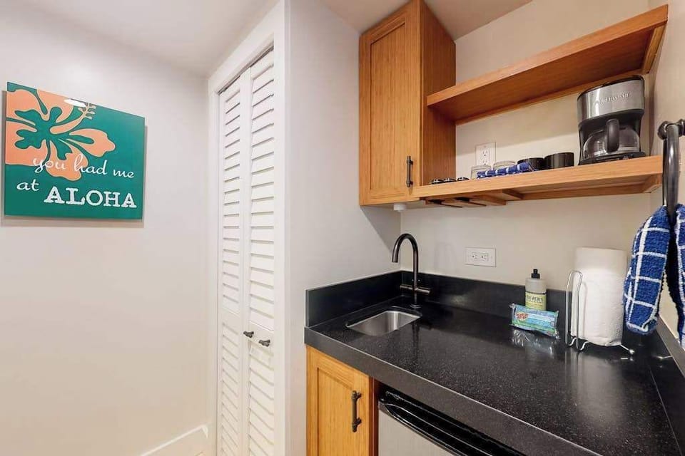 Kitchen includes cabinetry, coffee maker, and essentials