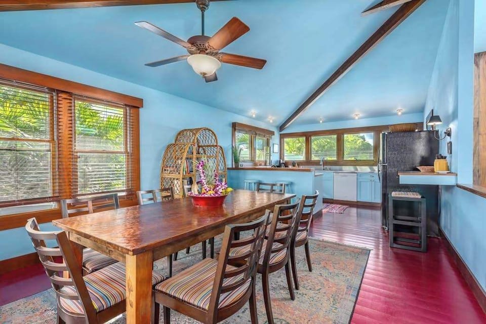 Open dining area combines seating, wood accents, and garden views