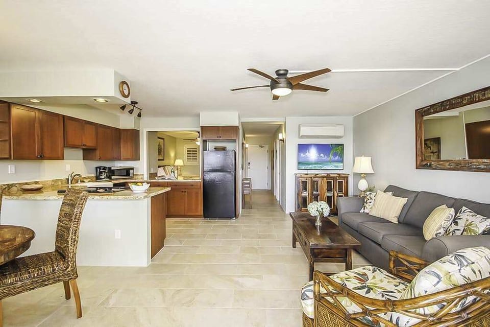Living room which is open to the dining room and kitchen in this open concept design.