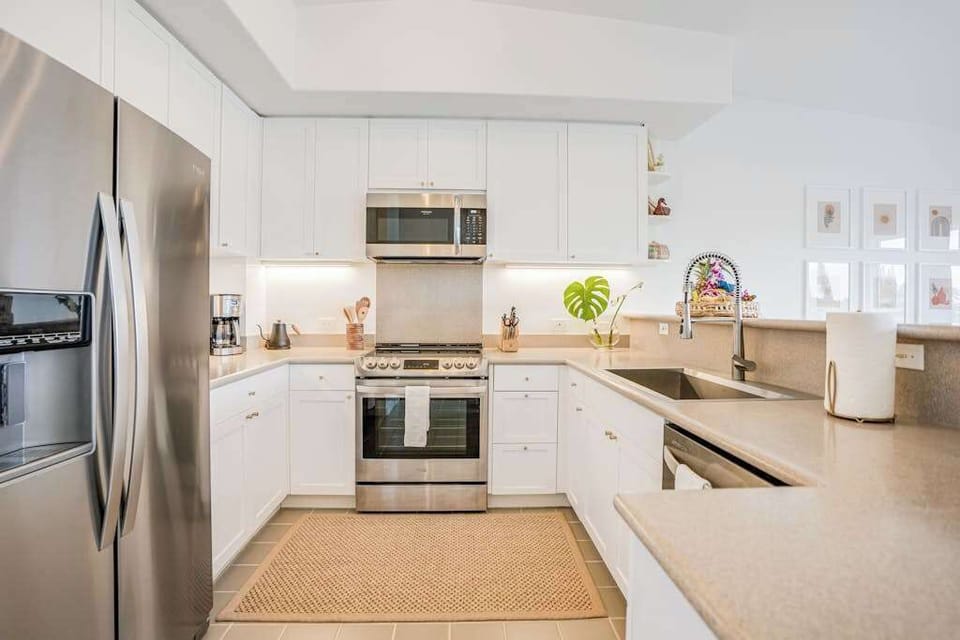 Modern kitchen with updated stainless steel appliances, spacious countertops, and ample cabinet storage
