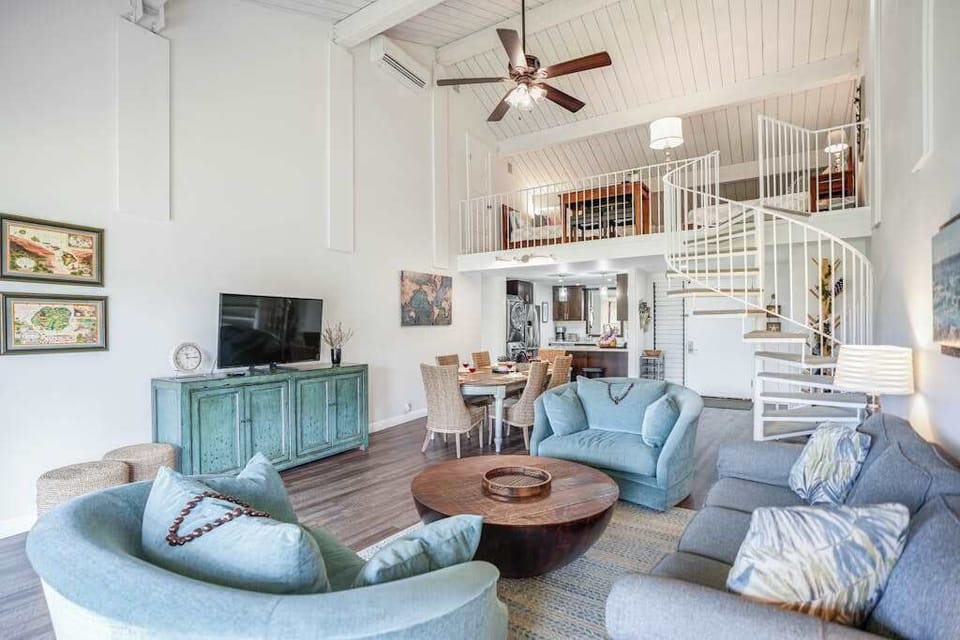 Spacious living area offers comfortable seating beneath soaring vaulted ceilings