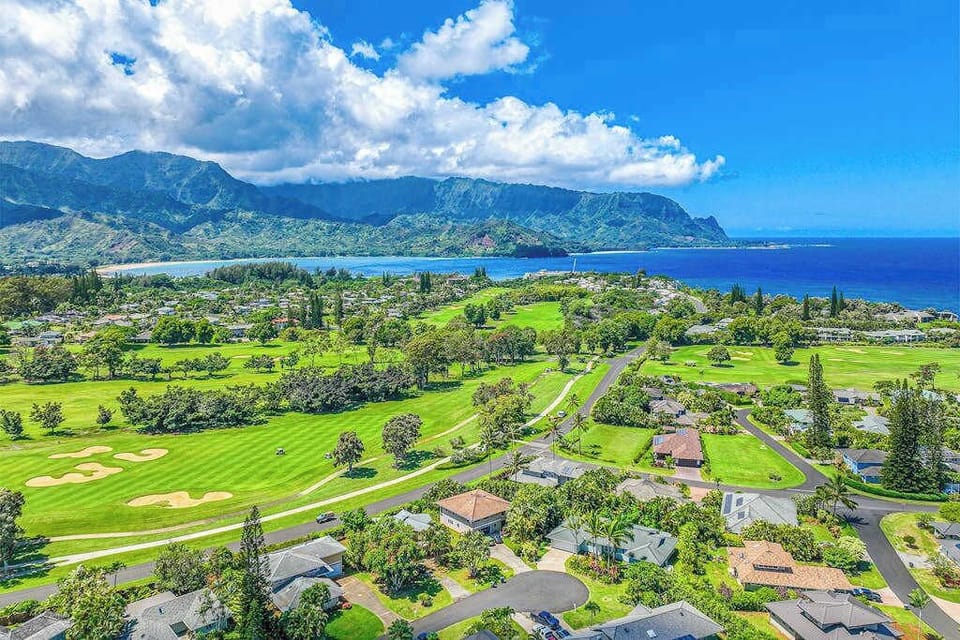 Homes surrounded by lush green golf courses and views of the coastline.