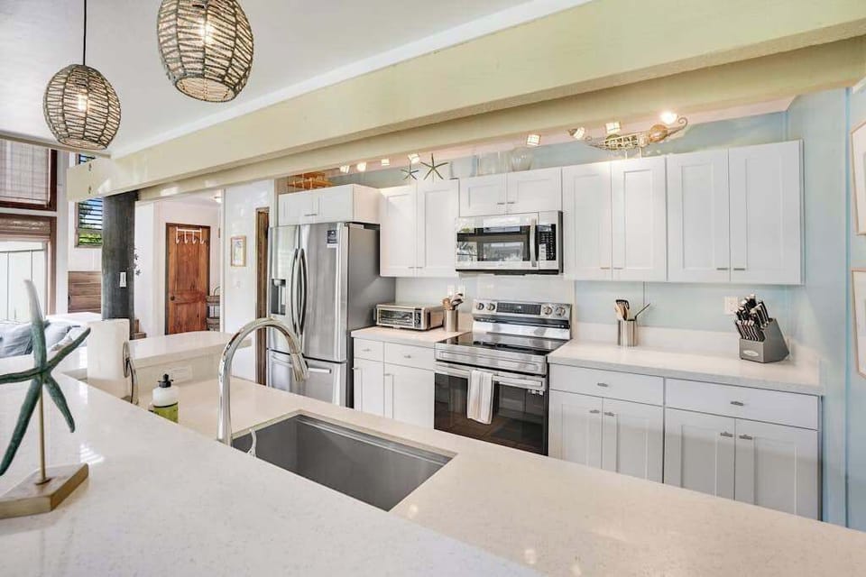 Newly remodeled modern kitchen featuring stainless steel appliances and an island for extra counter space.
