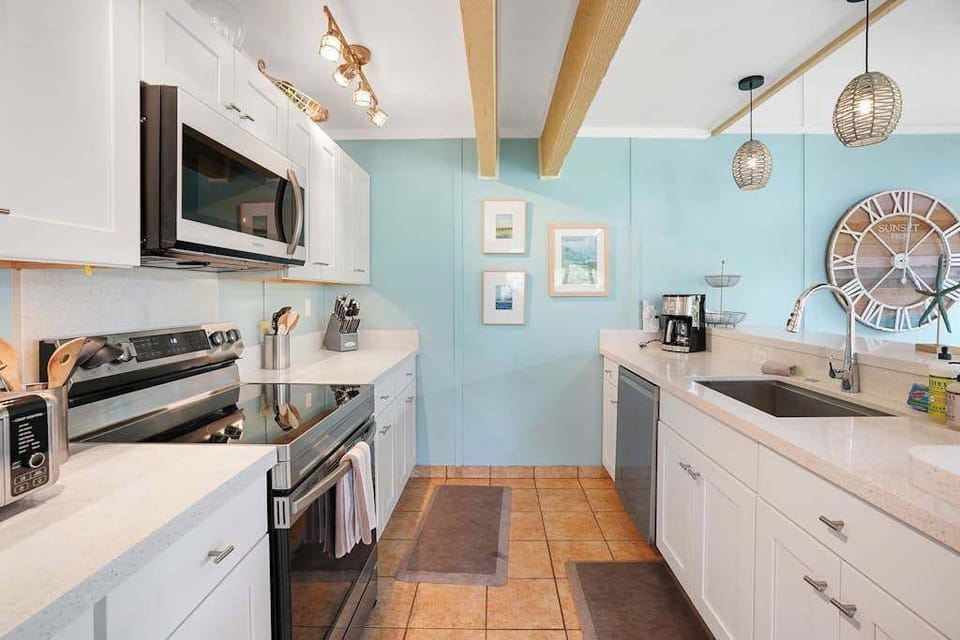 Newly remodeled modern kitchen featuring stainless steel appliances and an island for extra counter space.