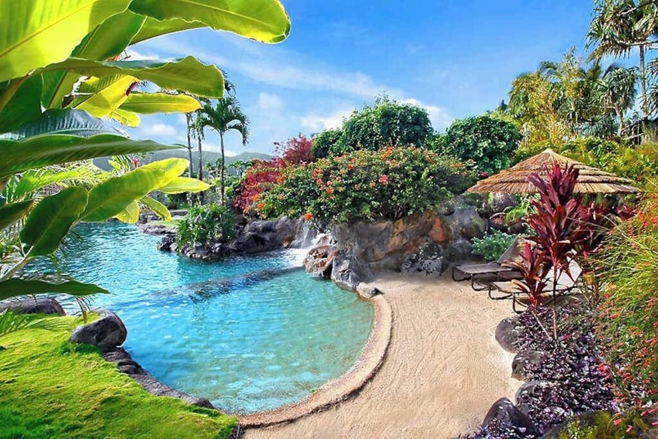 Sparkling pool offers calm waters, colorful gardens, and peaceful seating