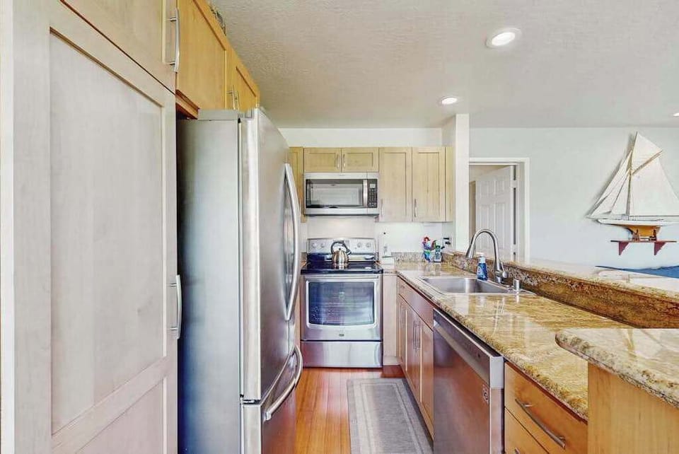 Modern kitchen showcases sleek cabinets, useful appliances, and generous counters