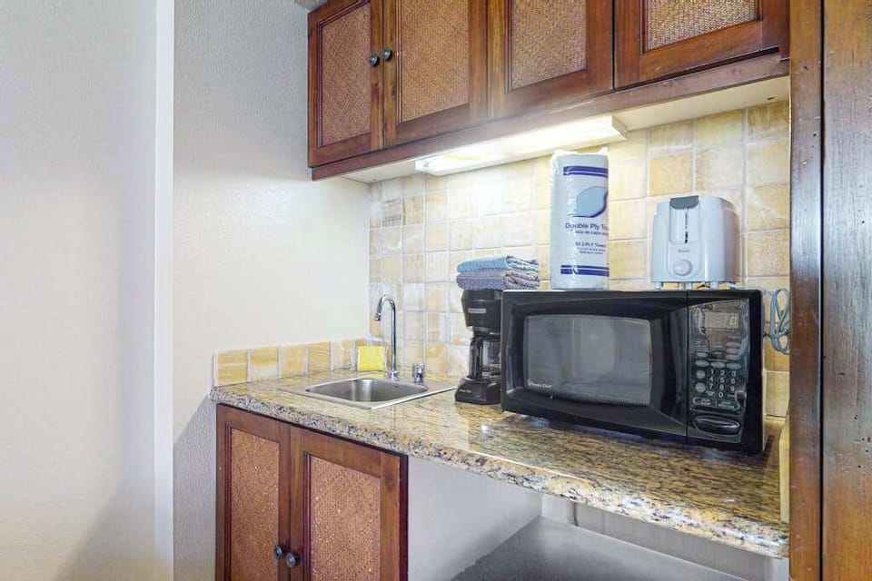 Cozy kitchenette with storage cabinets for preparing your meals.