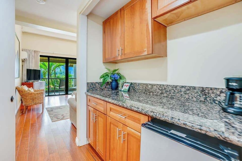 Well-equipped kitchen offers generous counter space, cabinetry, and natural light