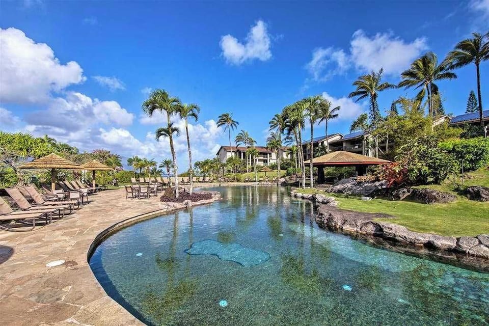 Relax beside the peaceful pool surrounded by lush tropical landscaping