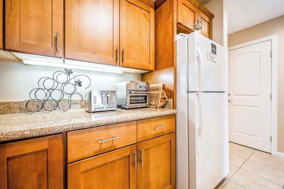 Kitchen cabinetry surrounds practical appliances and generous counter workspace area