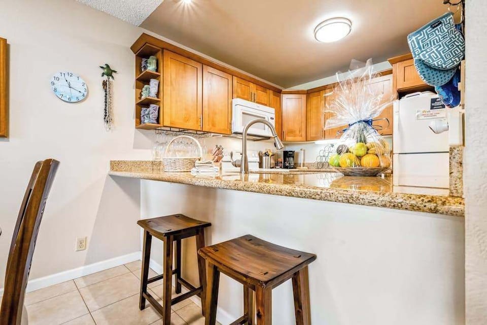 Fully equipped kitchen offers generous counters island seating and lighting