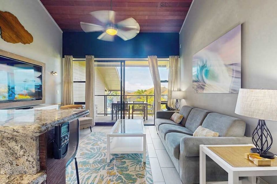 Bright lounge showcases white furnishings, ocean scenery, and coastal artwork