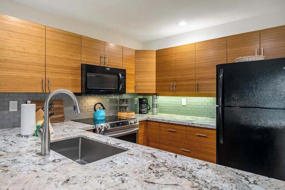 Kitchen counters offer efficient preparation space beneath practical cabinetry and appliances