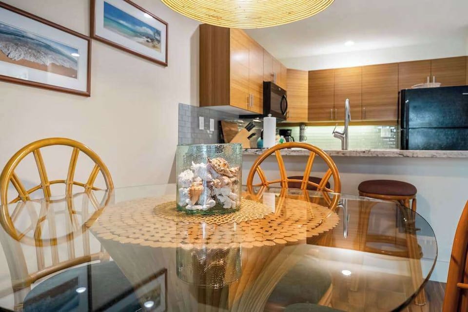 Rattan dining chairs gather around bright meals beside kitchen views