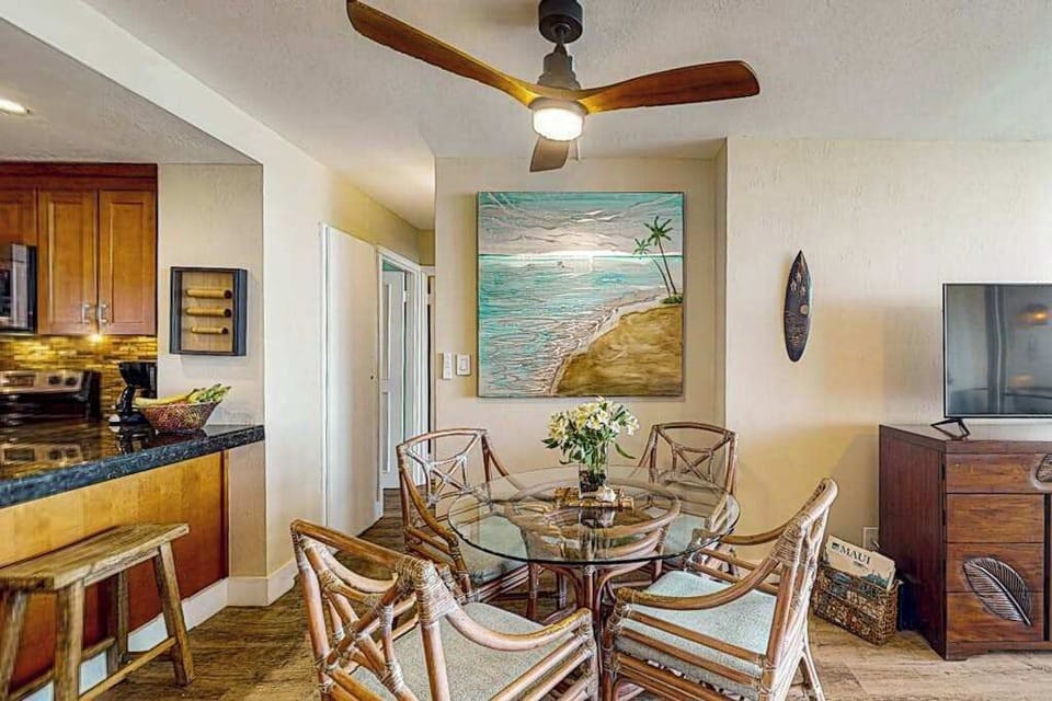 Dining room with seating for four and barstools at kitchen counter for extra seating. 