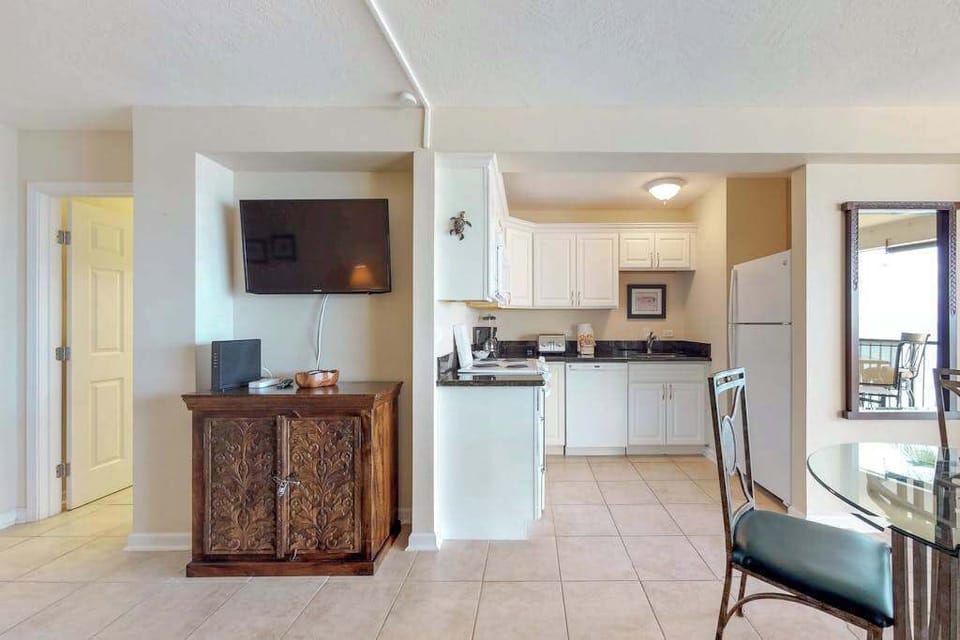 A fully equipped kitchen with a fridge, microwave, oven, and stovetop