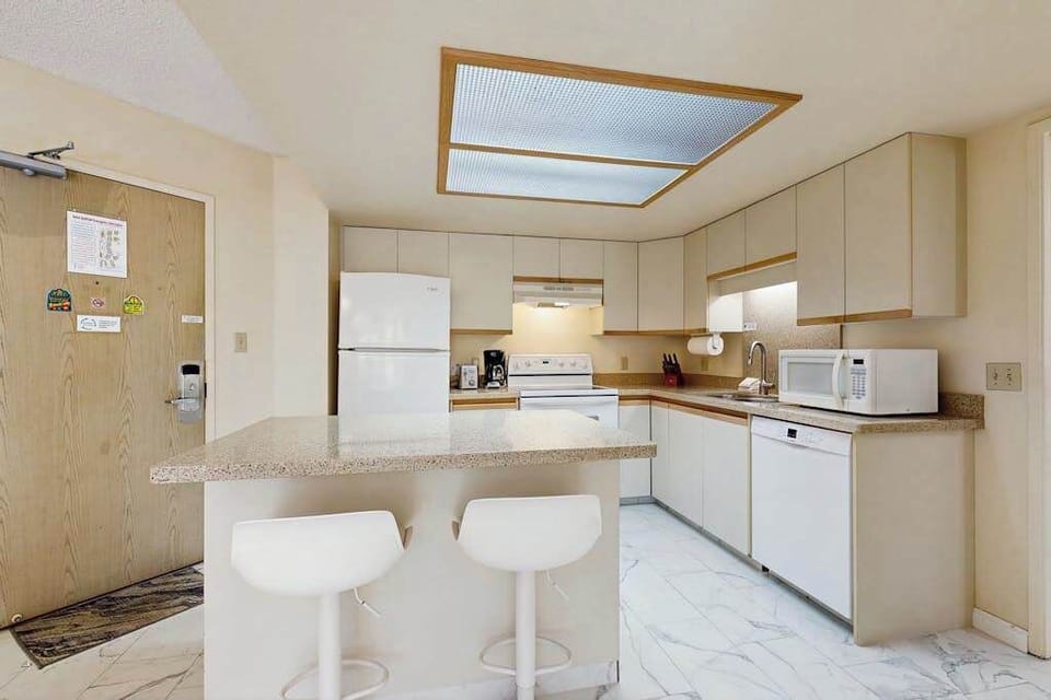 Bright kitchen with convenient breakfast bar seating
