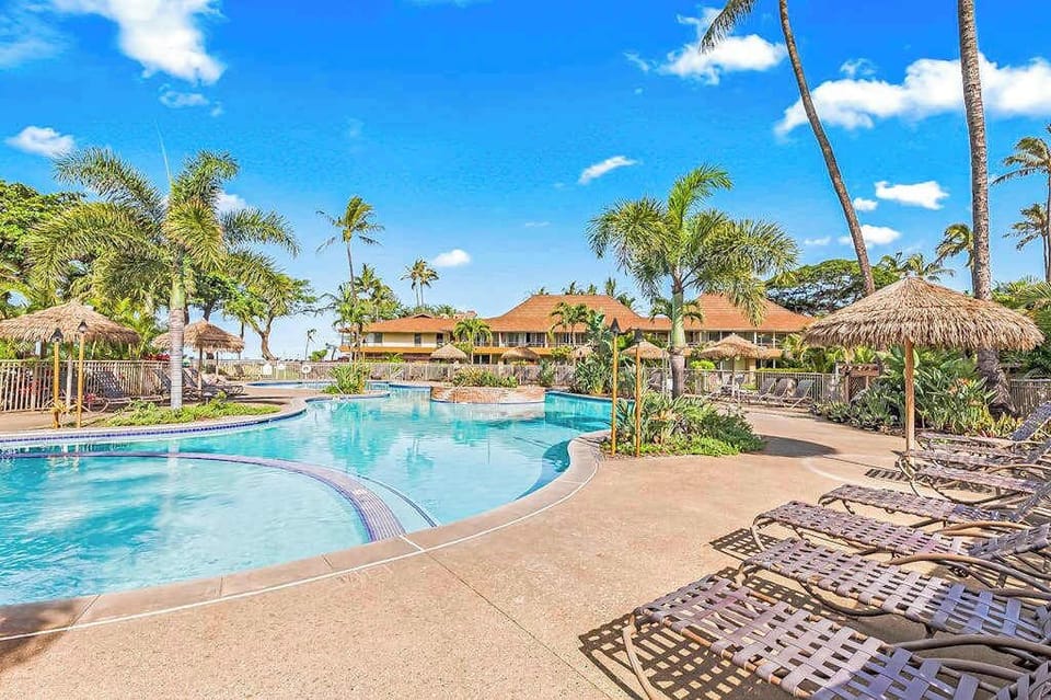 Relax by the resort-style pool surrounded by swaying palms and tropical landscaping.