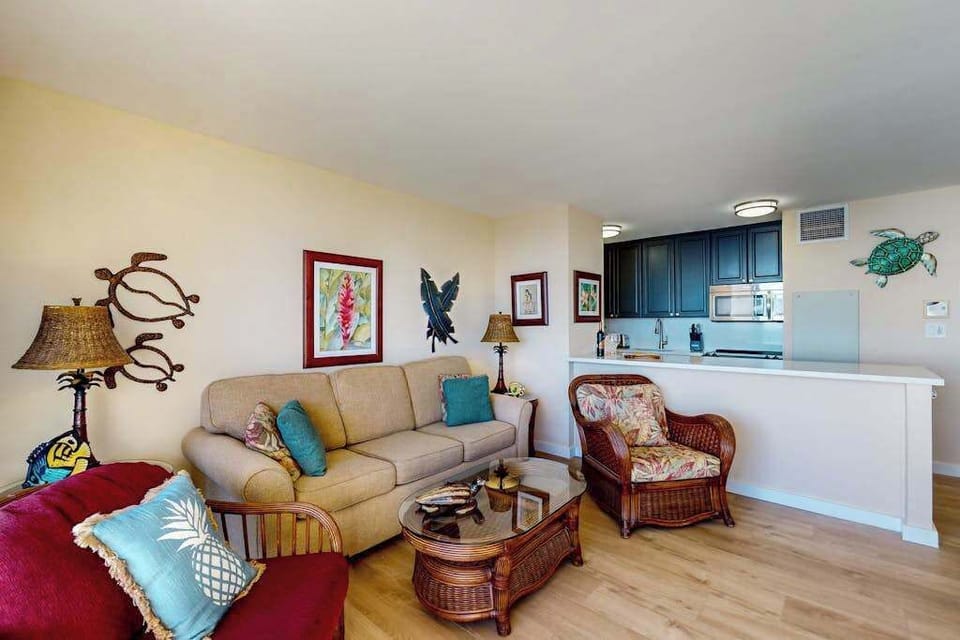 Bright living room with direct access to the private lanai, where beach views and swaying palm trees await.  With a comfortable sofa bed for extra company.