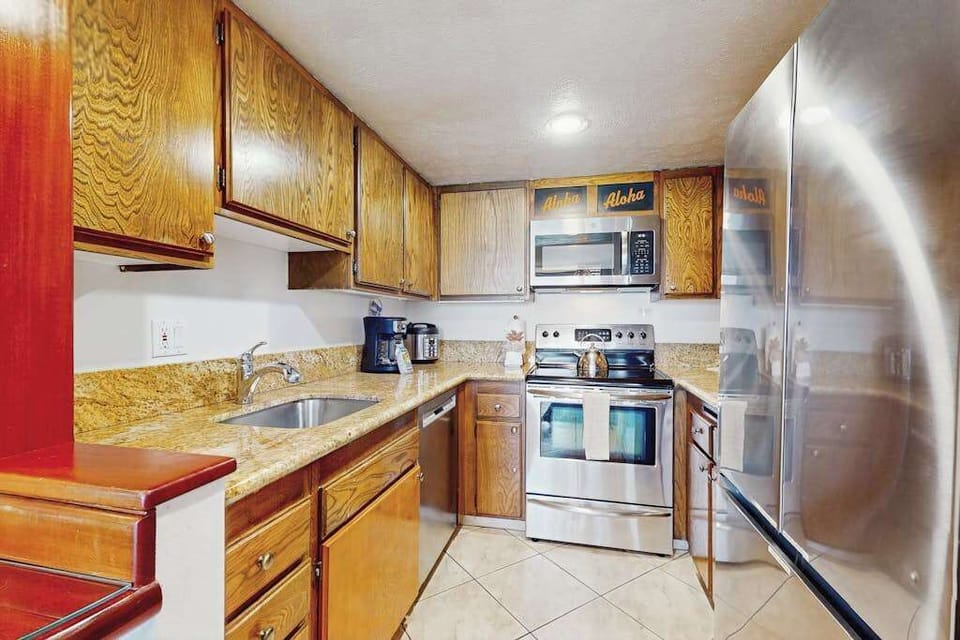 Prepare your favorite meals in the fully equipped kitchen featuring stainless steel appliances.