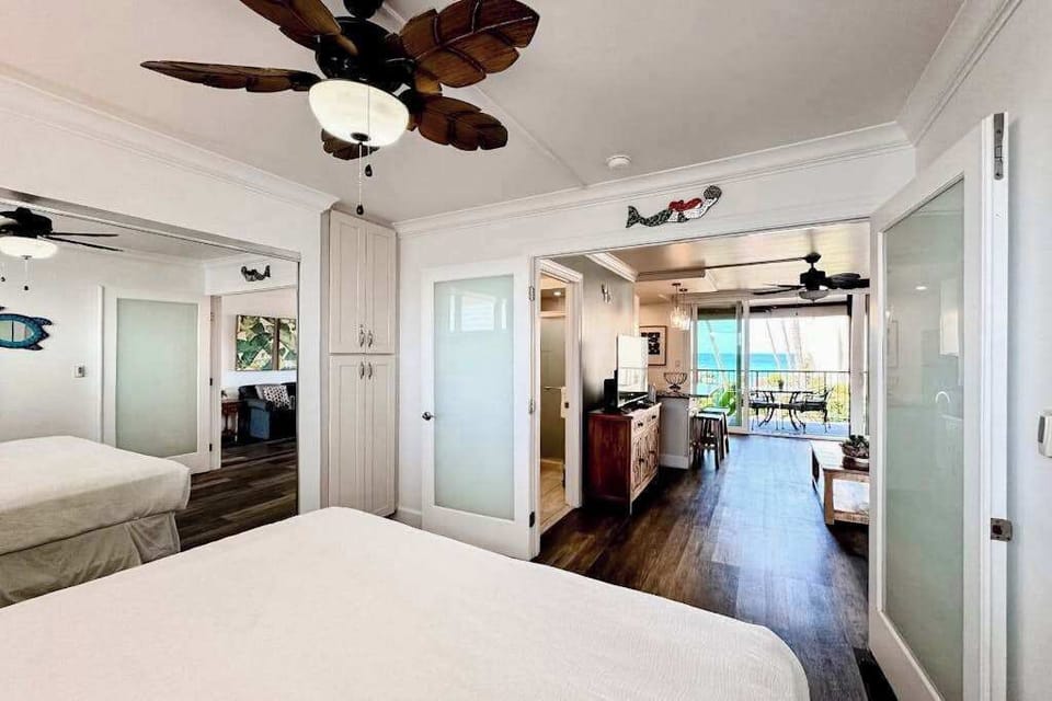 Restful bedroom presents soft linens, bedside tables, and natural light