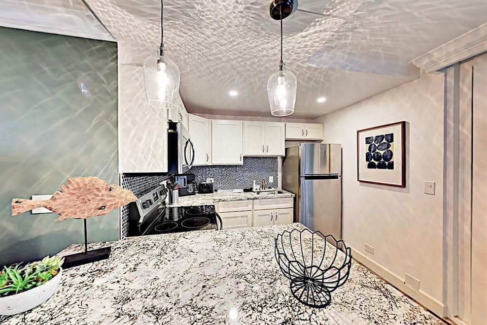Compact kitchen offers practical cabinetry, cooking appliances, and counter space