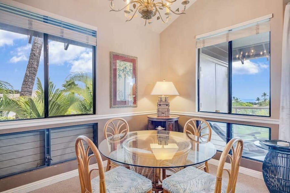 Sunlit Dining Nook with Glass-Top Table, Rattan Chairs & Ocean Views