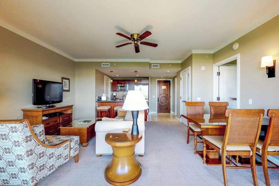 Beautiful dining space to share meals with loved ones, flowing perfectly into a cozy living area with comfortable seating and a TV.