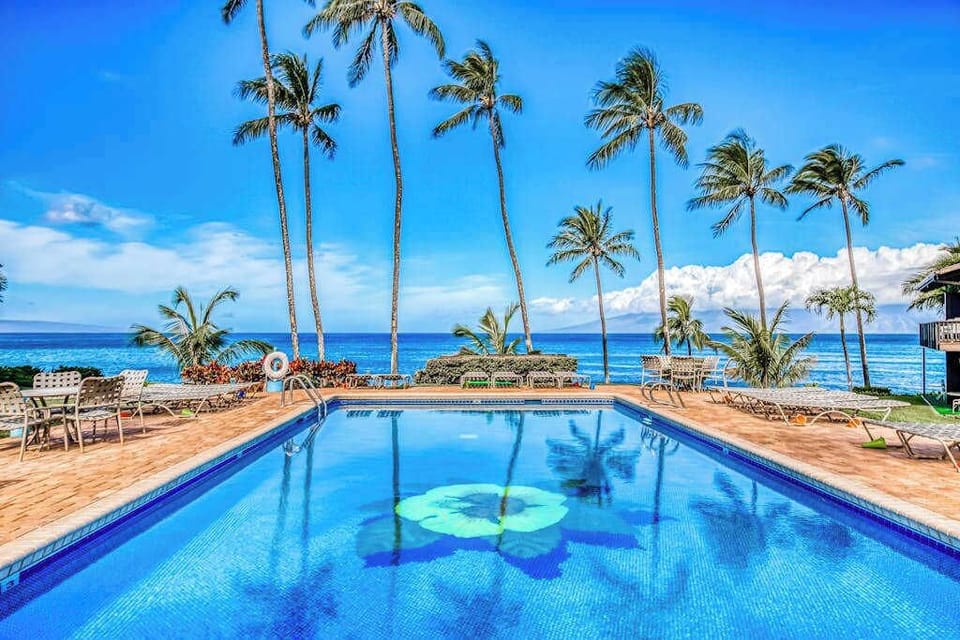 Resort Pool Surrounded By Swaying Palms