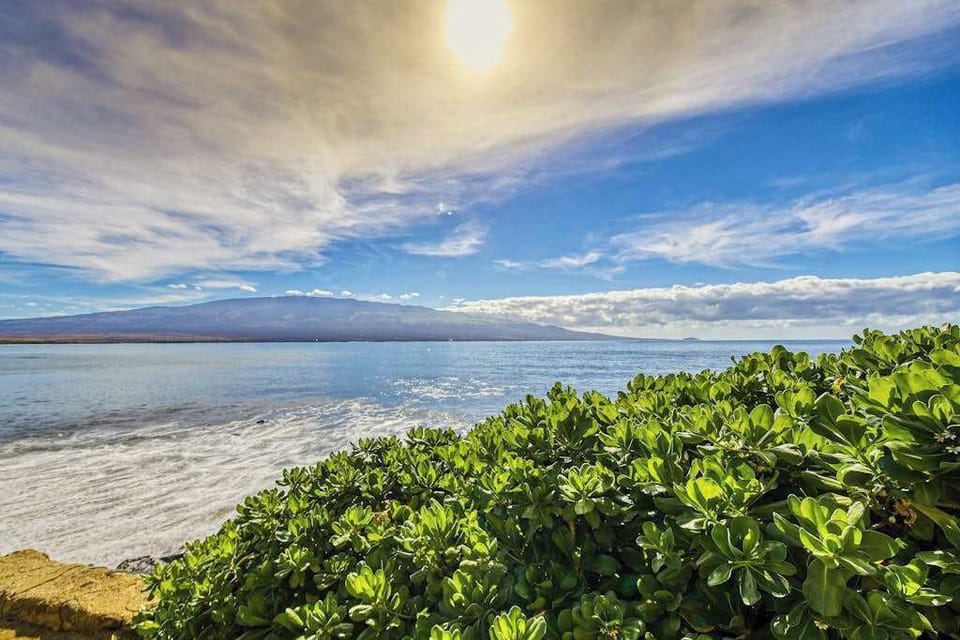 Crystal-clear turquoise waters gently wash onto pristine white sandy beaches.
