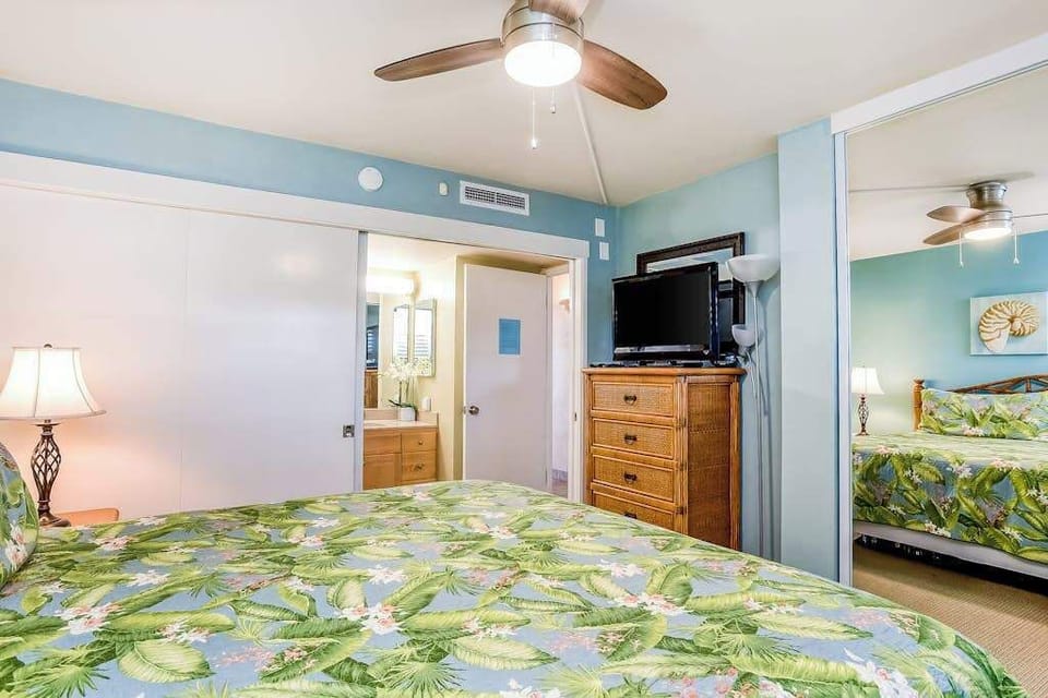 Master bedroom with king bed, ceiling fan, flat screen tv and en-suite bathroom