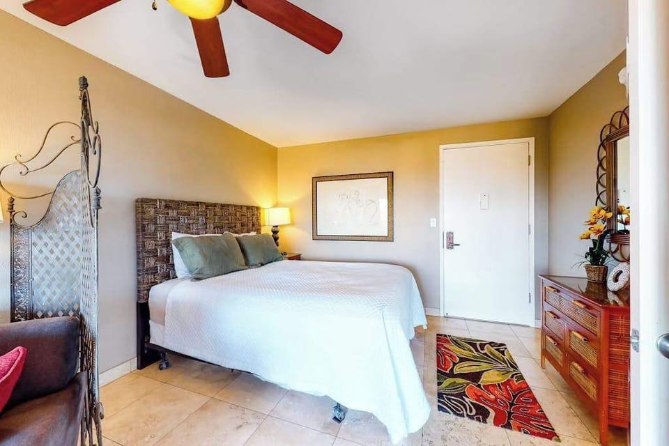 Bedroom with Plush Bed, Ceiling Fan, and Front Entry Access