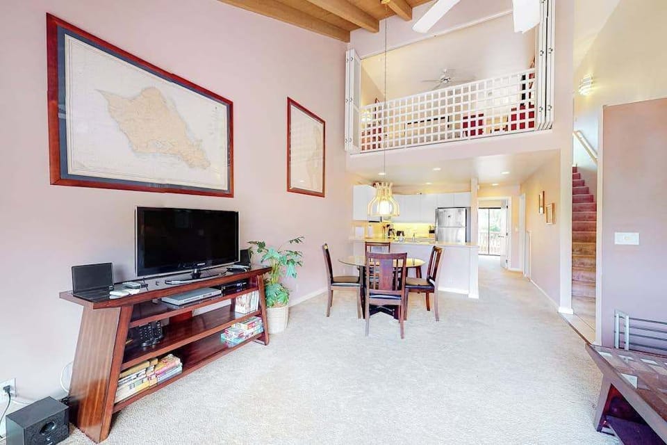 Living room features television seating and inviting open loft-style architecture