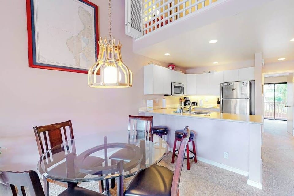 Kitchen dining area showcases modern appliances counters and breakfast seating