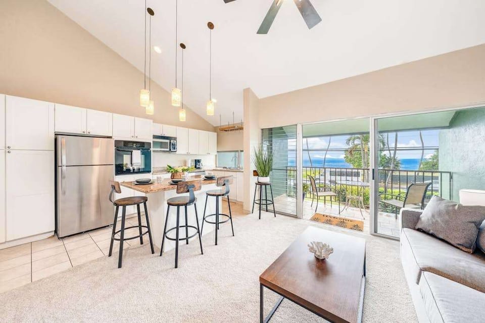 Open kitchen with island and breakfast bar