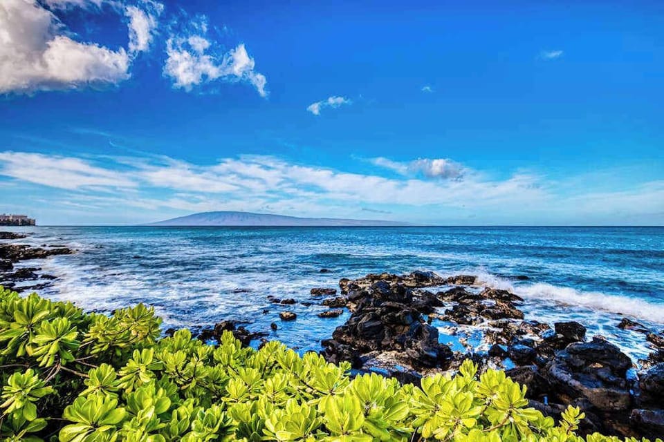 Watch the waves crash against the shoreline and lava rocks at Mahina Surf Resort while soaking in the beauty of the Pacific Ocean.