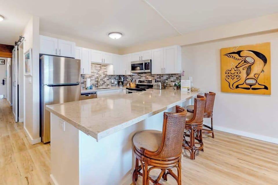 Modern kitchen with breakfast bar and ample counter space
