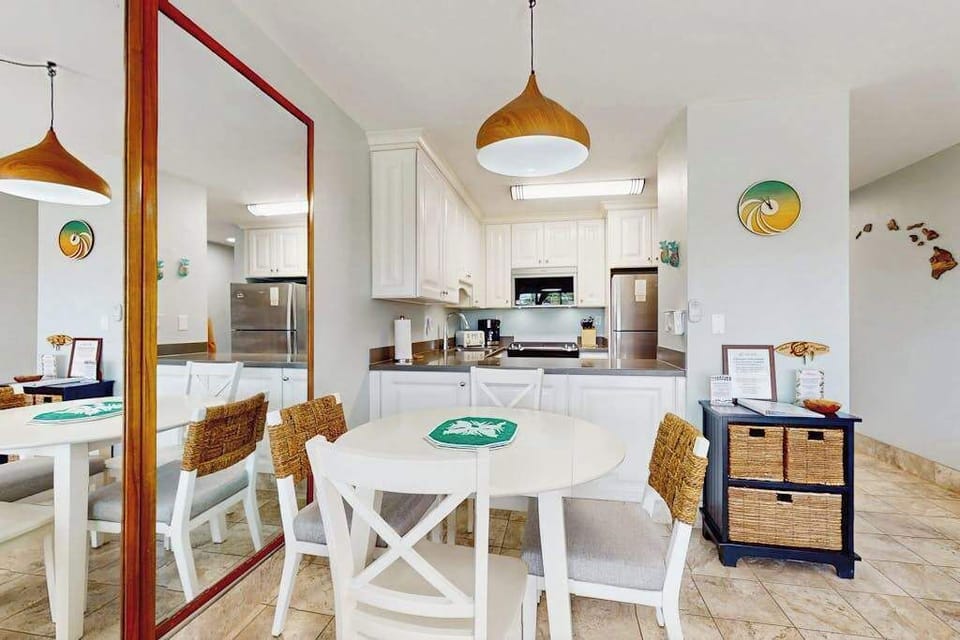 Dining table for four in an open-concept space that flows seamlessly into the living room.