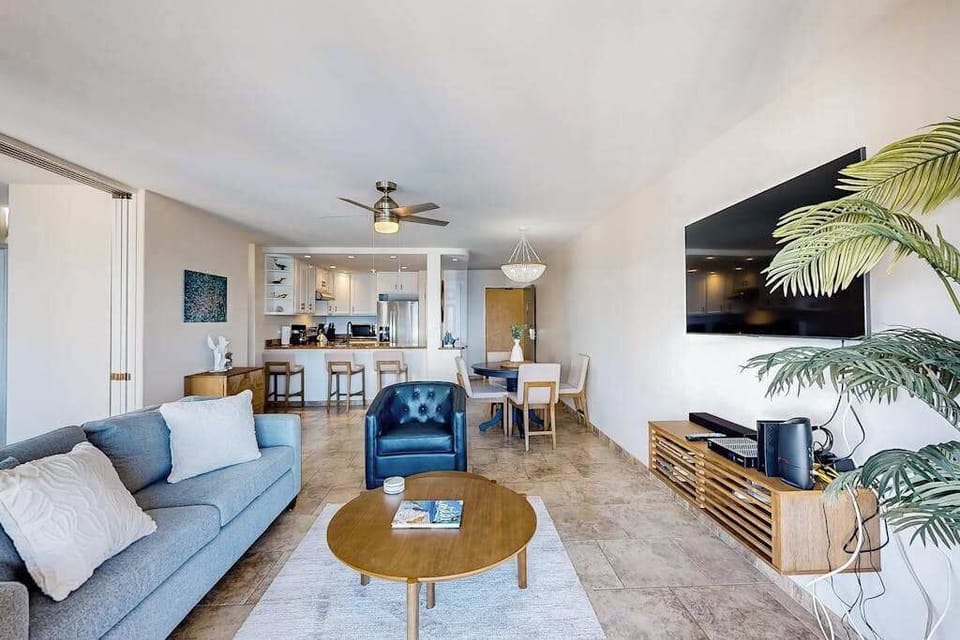 Bright living room with a balcony and a view of the ocean.