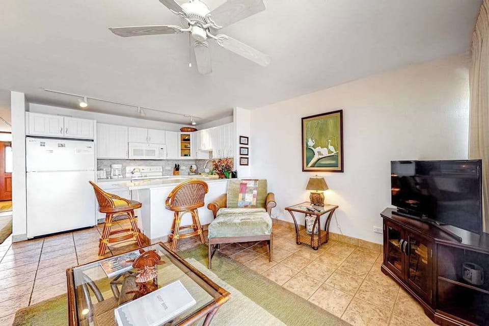 Bright living room with sliding glass doors, abundant natural light and flatscreen tv.