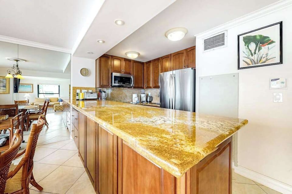 This newly remodeled kitchen with stainless steel appliances.  Large kitchen countertop for all the chef's prep needs and open to the dining room so that you are always with your company.
