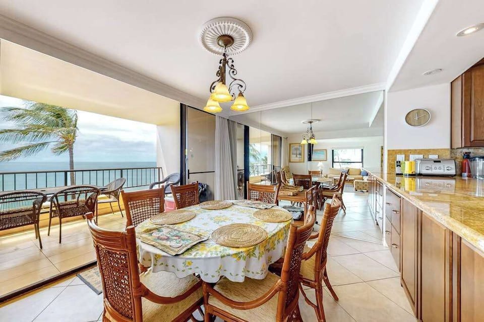 Dining room table with seating for six and open to the kitchen and you can feel the ocean breeze when you open the sliders to the lanai.